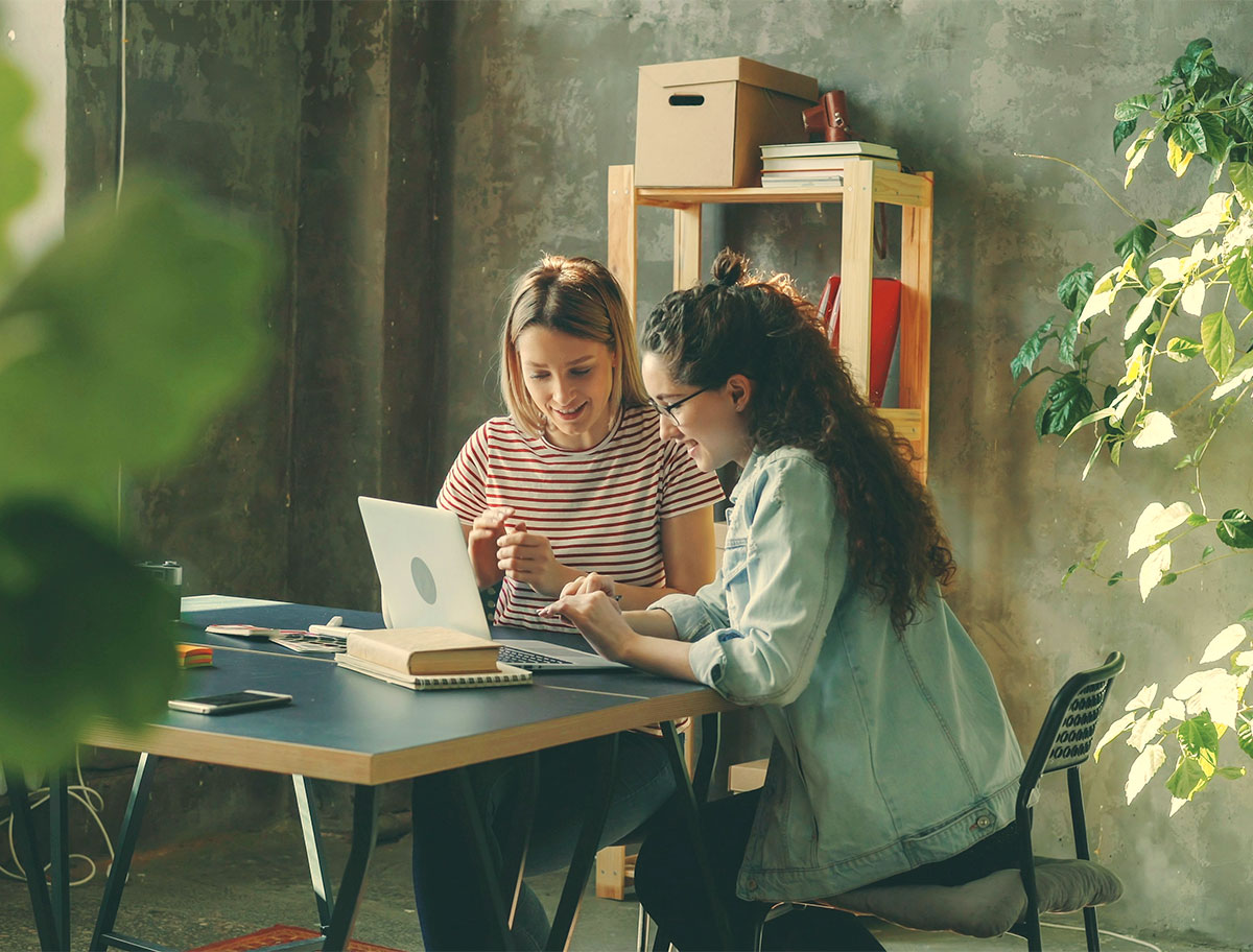 Two people working together at a laptop